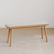 Legnano light wood dining bench with cream cushioned seat