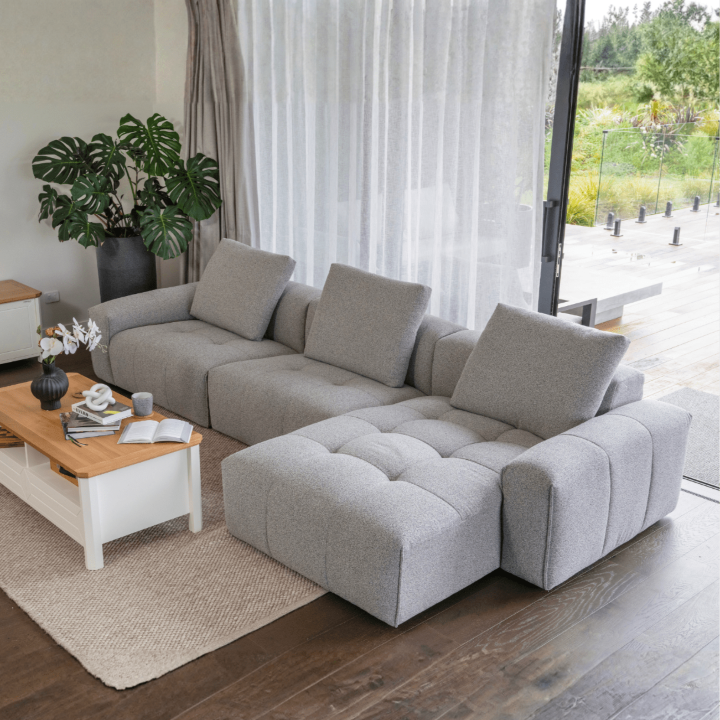 Bosa Lux light grey modular sofa with chaise by floor-to-ceiling windows