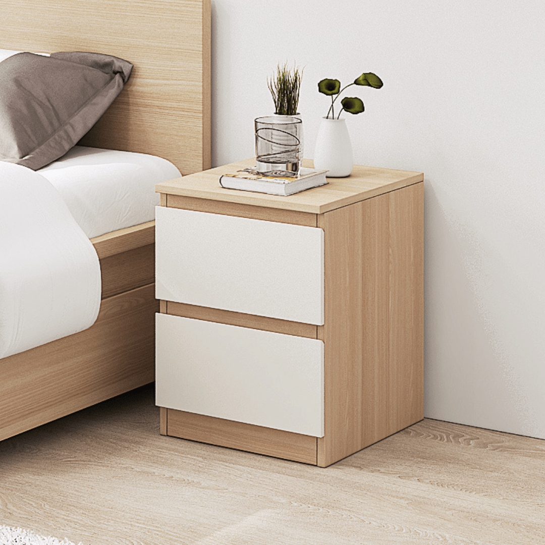 Molise white and oak two drawer bedside table beside a bed