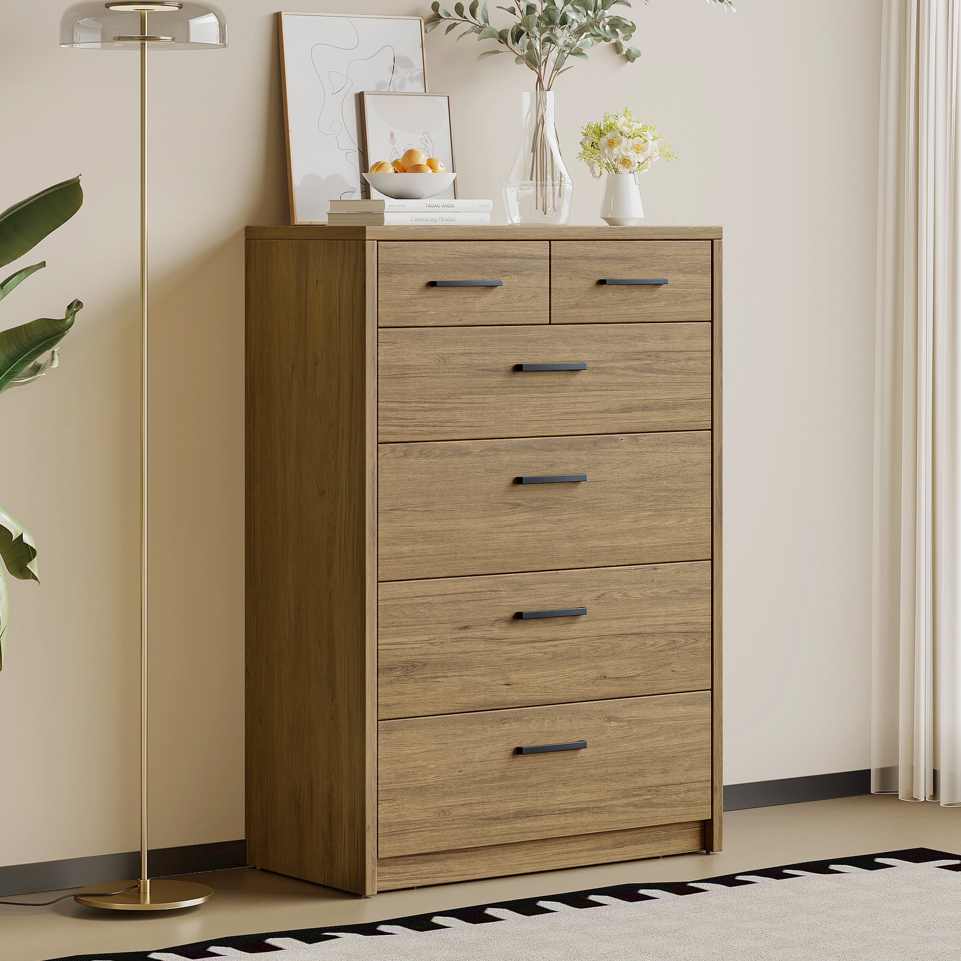 Platsa grey oak six drawer tallboy beside a brass floor lamp