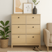 Modica natural oak shoe cabinet with six flip drawers beside an armchair
