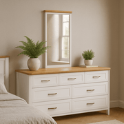 Stoven white framed mirror with wood trim on a matching dresser