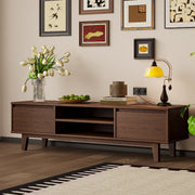 Arezzo walnut TV stand with mid-century legs below a gallery wall
