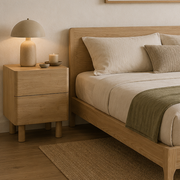 Aria rounded light wood bedside table styled beside a bed
