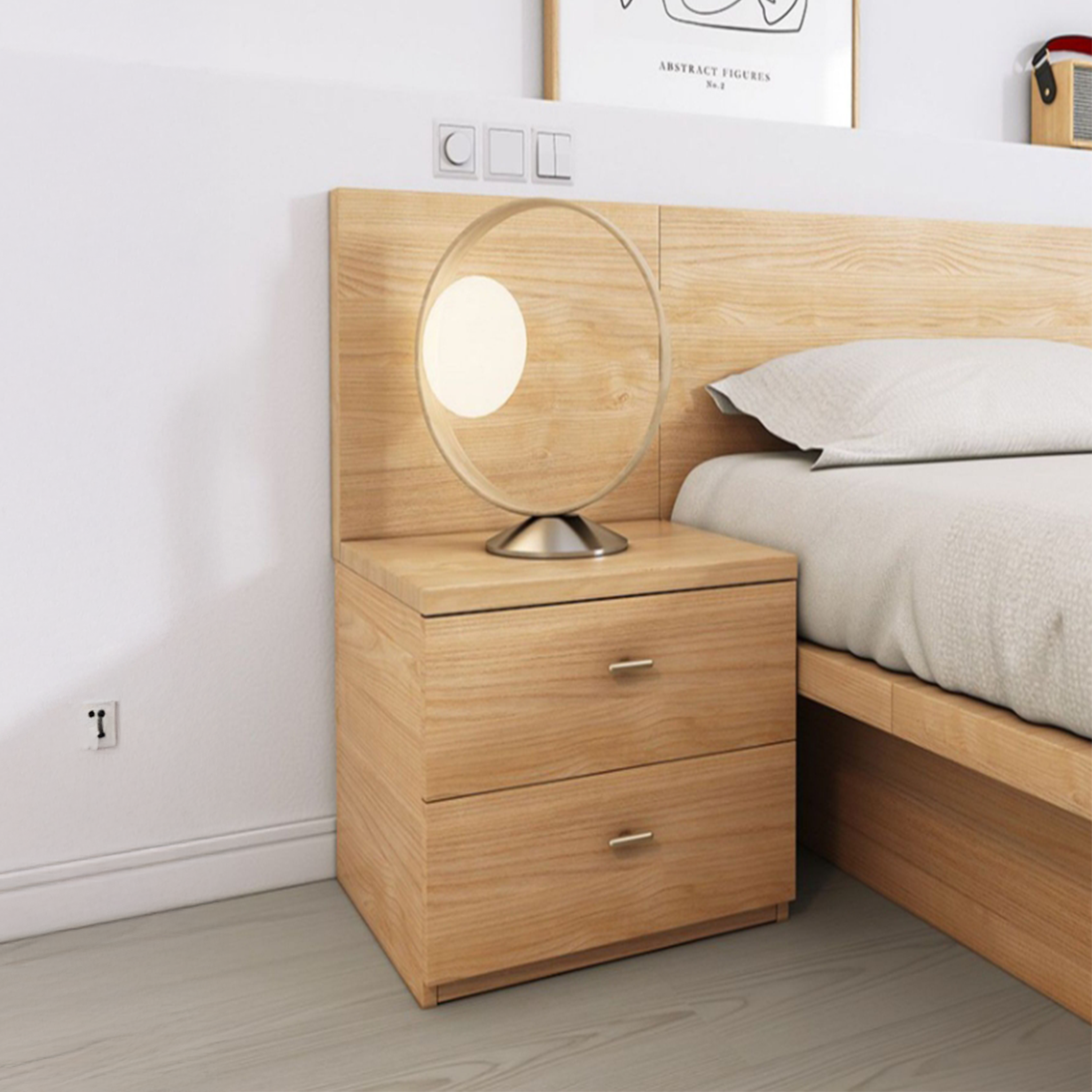 Ovada light oak bedside table with copper handles beside a bed