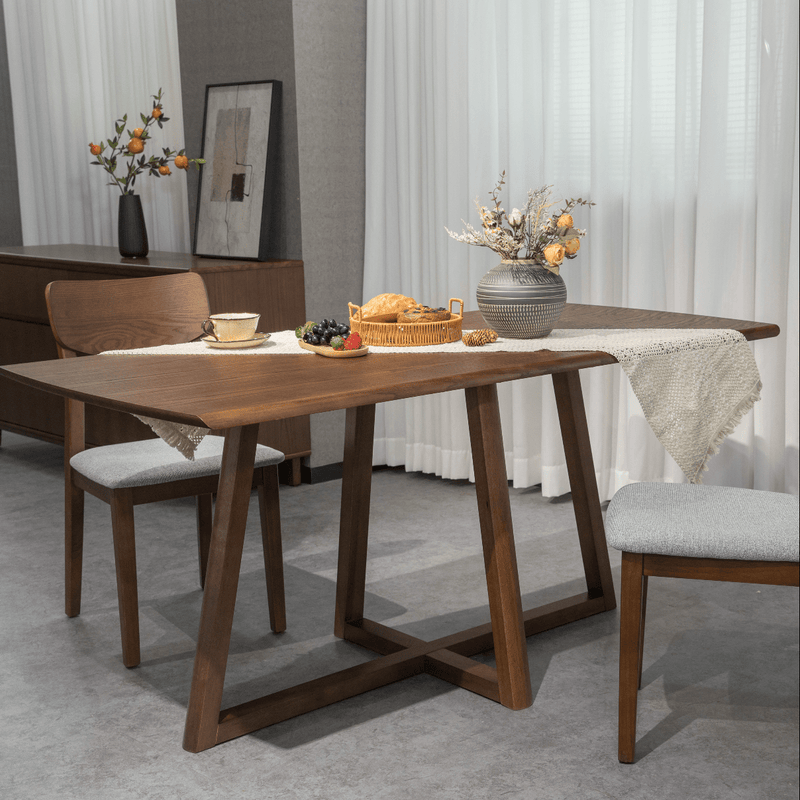 Walnut timber dining table with two upholstered dining chairs in a dining room
