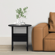 Ranco round black side table with drawer and shelf beside a tan leather sofa