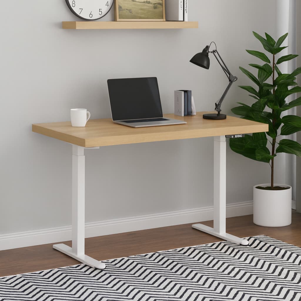 A light wood and white height-adjustable standing desk styled in a home office setting with a laptop, lamp, mug, shelf, and potted plant.